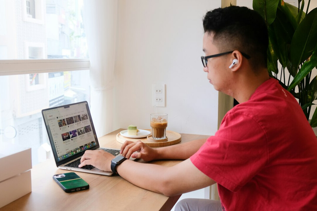 japanese student coding on laptop