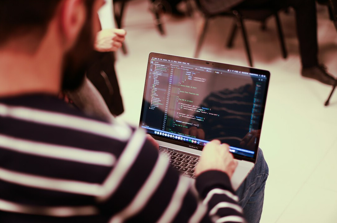 japanese student coding on laptop